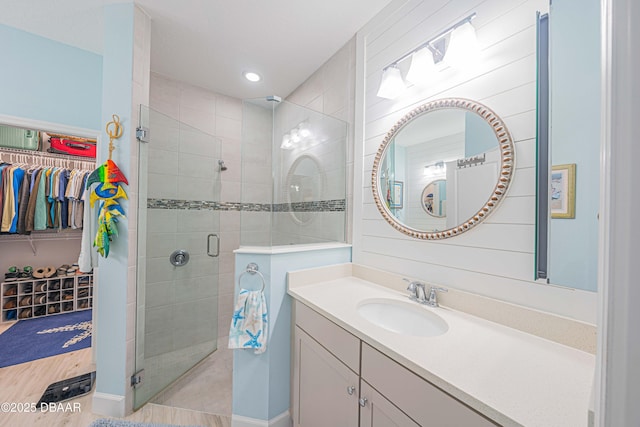 bathroom with walk in shower and vanity