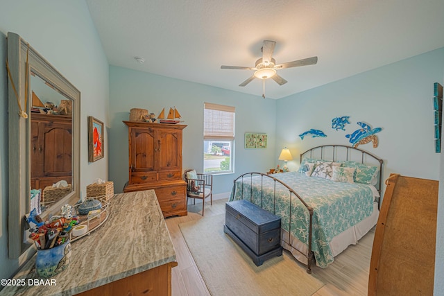 bedroom with ceiling fan and light hardwood / wood-style flooring