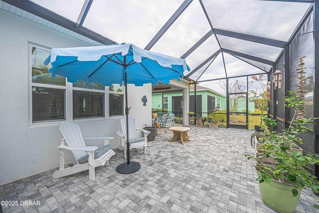 view of patio with glass enclosure