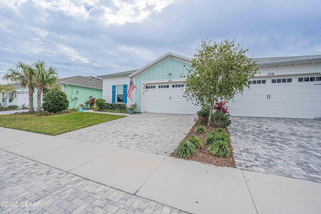 ranch-style home with a front yard and a garage