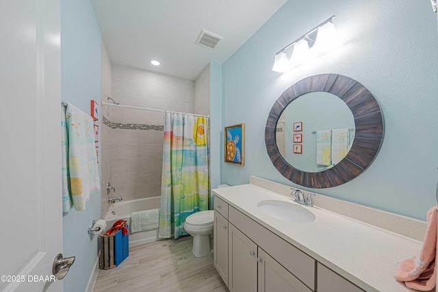 full bathroom with hardwood / wood-style floors, toilet, vanity, and shower / bath combo