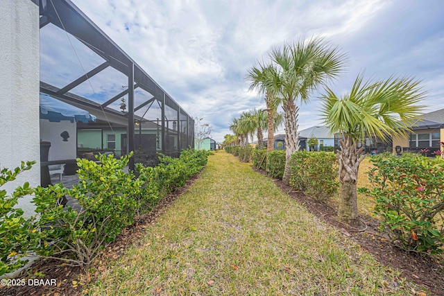 view of yard with a lanai