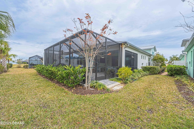 back of property featuring a yard and glass enclosure