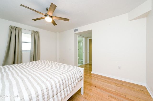 bedroom with hardwood / wood-style floors, ensuite bath, and ceiling fan