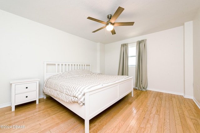 bedroom with ceiling fan and light wood-type flooring