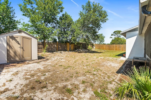 1197 Stillwood Ct, Port Orange, FL 32129 - view of yard featuring a fenced backyard, an outbuilding, and a storage unit