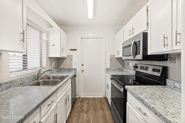 1197 Stillwood Ct, Port Orange, FL 32129 - kitchen featuring a sink, backsplash, white cabinetry, dark wood-type flooring, and appliances with stainless steel finishes