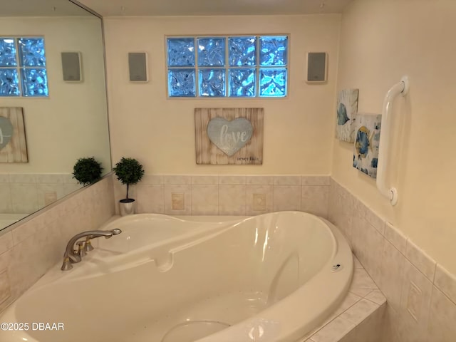 bathroom featuring a relaxing tiled tub