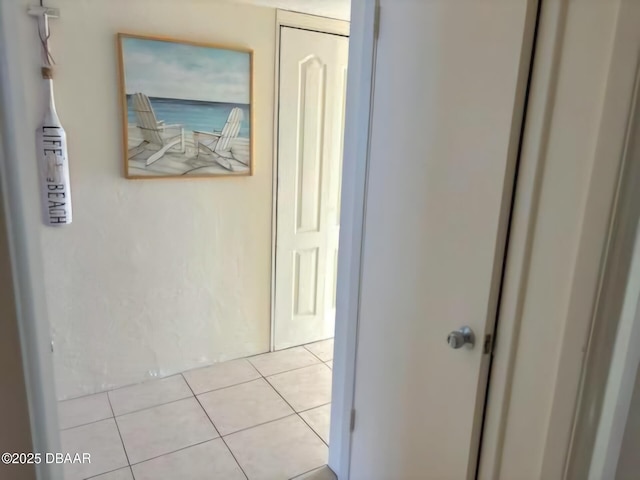 hall featuring light tile patterned flooring