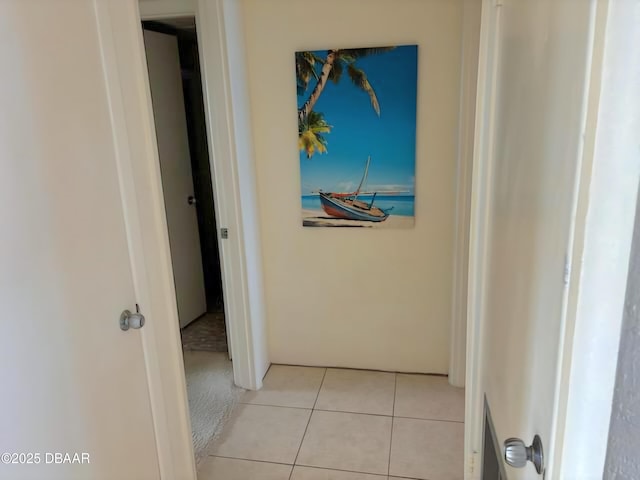 hall featuring light tile patterned floors