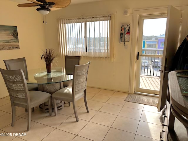 dining room with light tile patterned floors, plenty of natural light, and ceiling fan