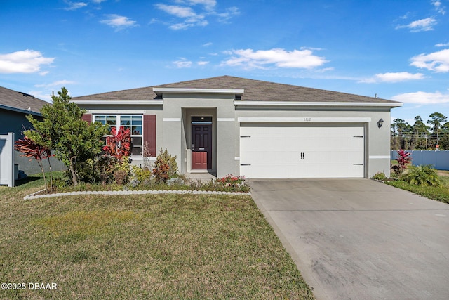 view of front of home with a garage and a front lawn