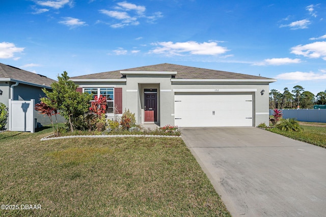 view of front of house featuring a garage and a front lawn