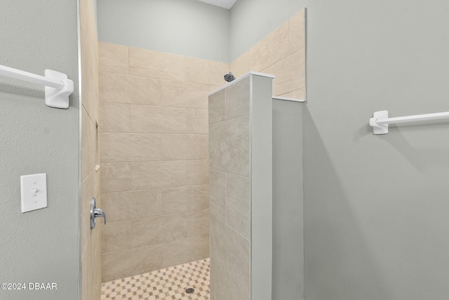 bathroom with a tile shower