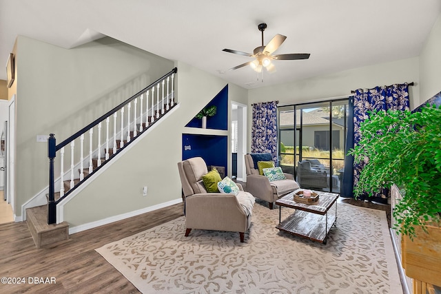 living room featuring hardwood / wood-style floors and ceiling fan