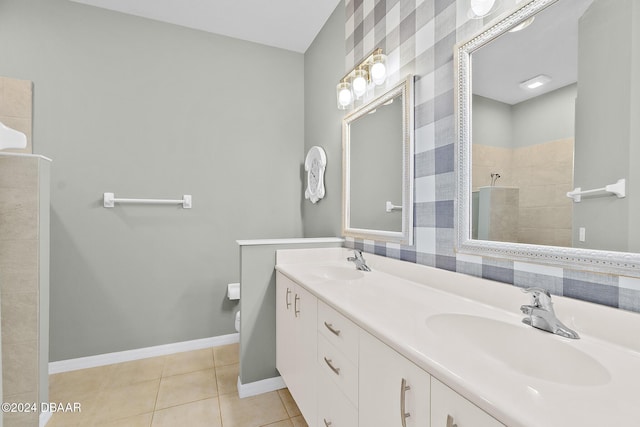 bathroom with tile patterned flooring, vanity, toilet, and a shower