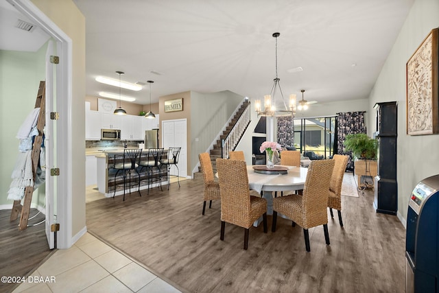 dining room with a chandelier and light hardwood / wood-style flooring