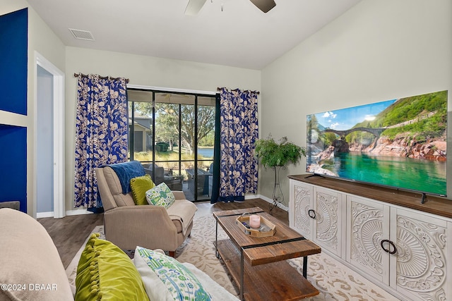 living room featuring ceiling fan, light hardwood / wood-style flooring, and lofted ceiling