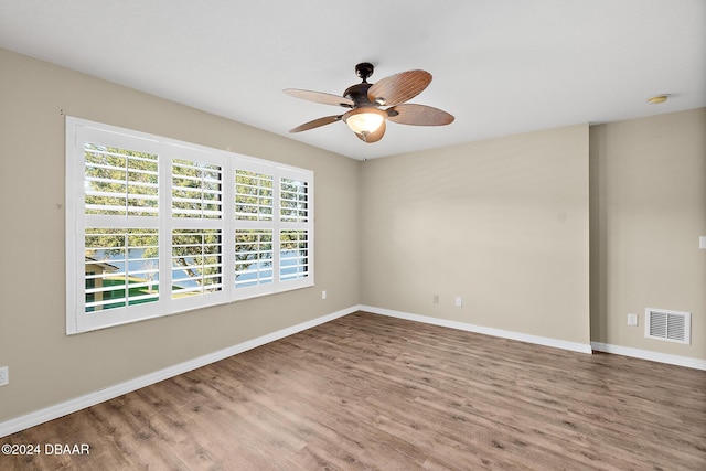 empty room featuring wood-type flooring and ceiling fan