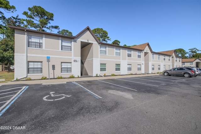 view of building exterior with uncovered parking