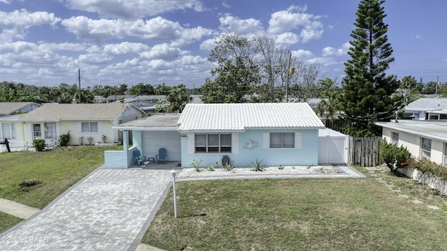 39 Seaview Dr, Ormond Beach, FL 32176 - ranch-style home featuring decorative driveway, a gate, fence, a tile roof, and a front lawn