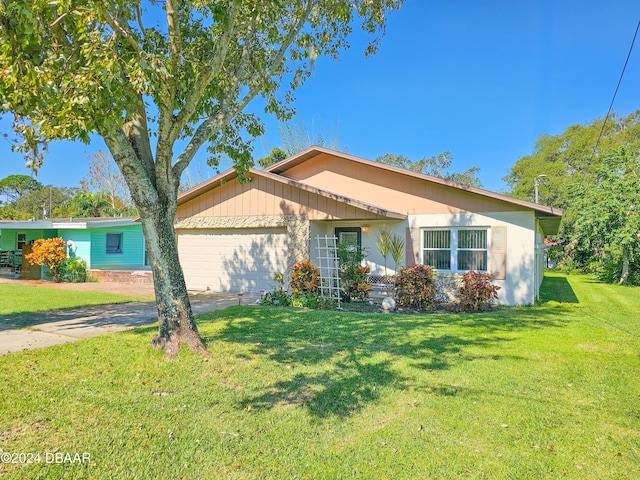 ranch-style house with a garage and a front lawn