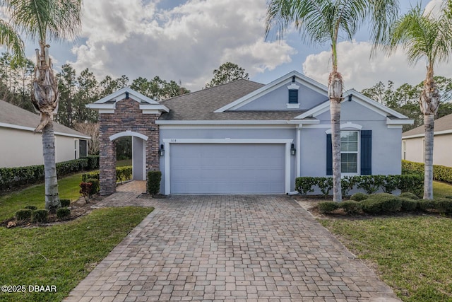 ranch-style home with a garage and a front yard