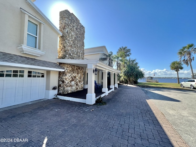 exterior space with a water view and a porch