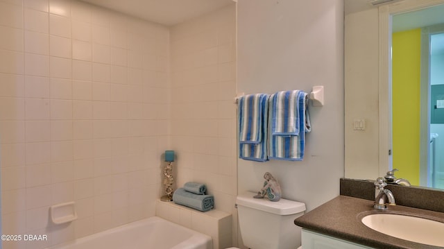 bathroom featuring vanity, toilet, and a bathing tub