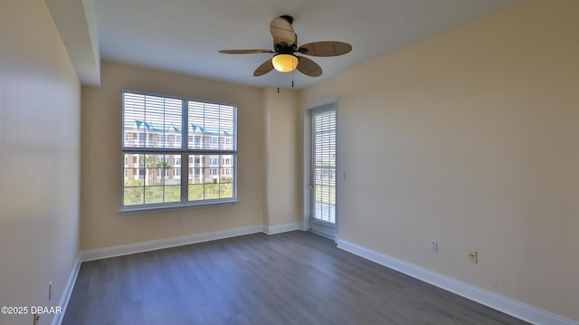 unfurnished room with dark hardwood / wood-style floors and ceiling fan