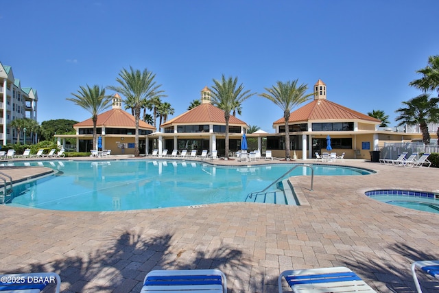 view of swimming pool featuring a gazebo, a community hot tub, and a patio area