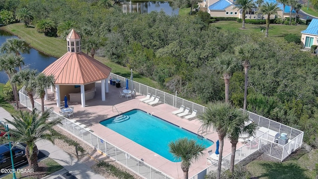 view of swimming pool featuring a gazebo, a water view, and a patio area