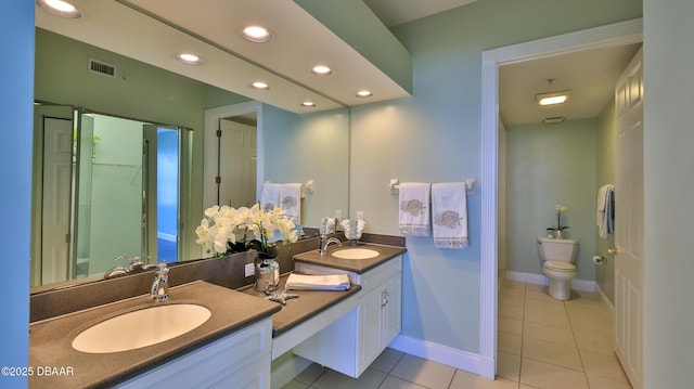 bathroom featuring vanity, tile patterned floors, and toilet