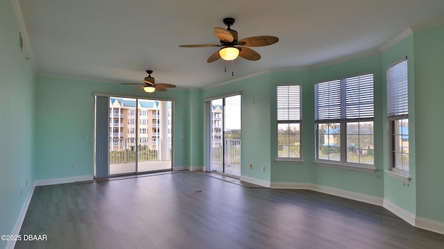 empty room featuring crown molding and dark hardwood / wood-style floors