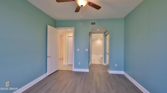 unfurnished bedroom featuring ceiling fan, light hardwood / wood-style flooring, and a textured ceiling