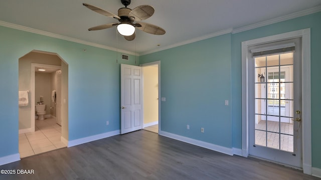 unfurnished bedroom with crown molding, ceiling fan, wood-type flooring, and connected bathroom