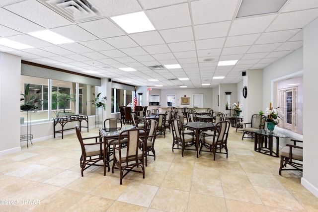 dining space featuring a drop ceiling