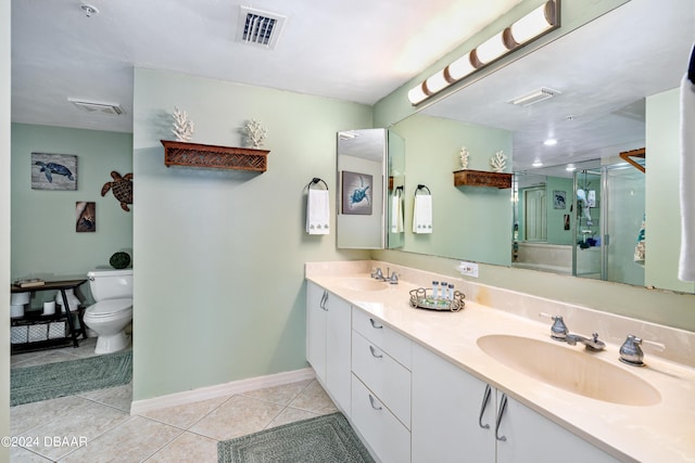 bathroom featuring toilet, tile patterned flooring, a shower with door, and vanity