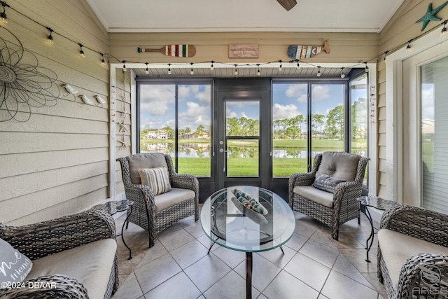 sunroom / solarium featuring a water view and lofted ceiling