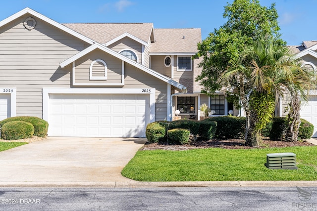 view of front facade with a garage and a front lawn