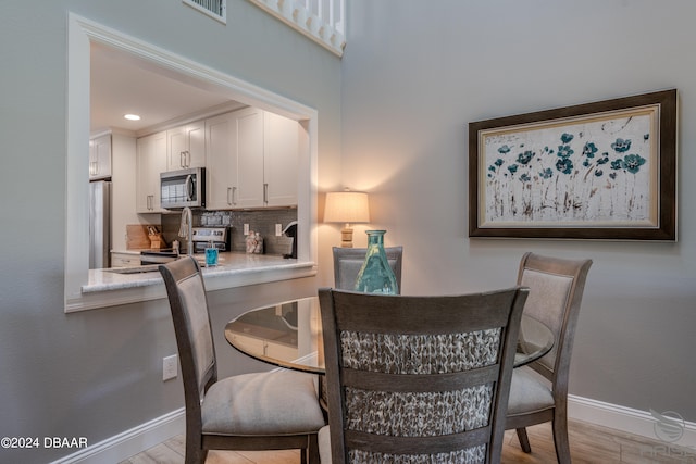 dining area with light hardwood / wood-style flooring