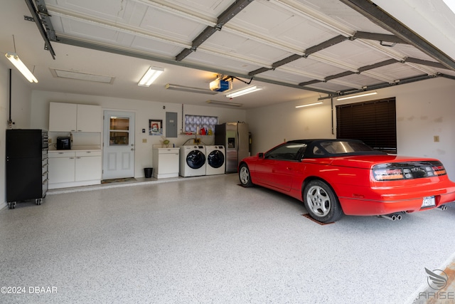 garage featuring a garage door opener, stainless steel fridge, electric panel, and separate washer and dryer