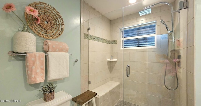 bathroom with a shower stall and toilet
