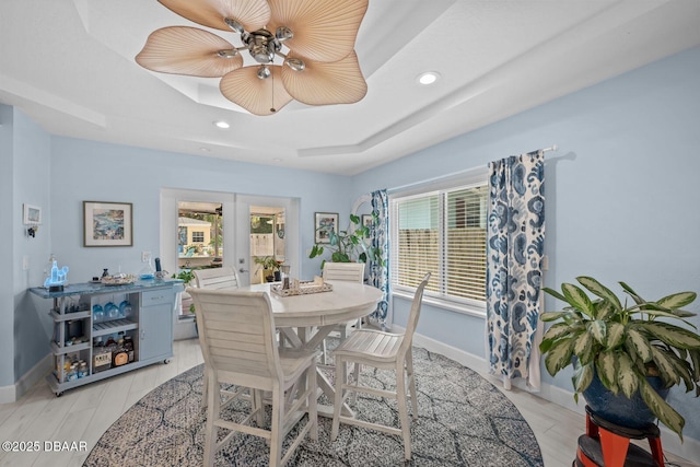 1942 N Daytona Ave, Flagler Beach, FL 32136 - dining space with french doors, baseboards, a tray ceiling, recessed lighting, and light wood-style flooring