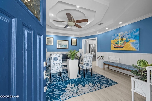 1942 N Daytona Ave, Flagler Beach, FL 32136 - dining space featuring ornamental molding, ceiling fan, a tray ceiling, wainscoting, and recessed lighting