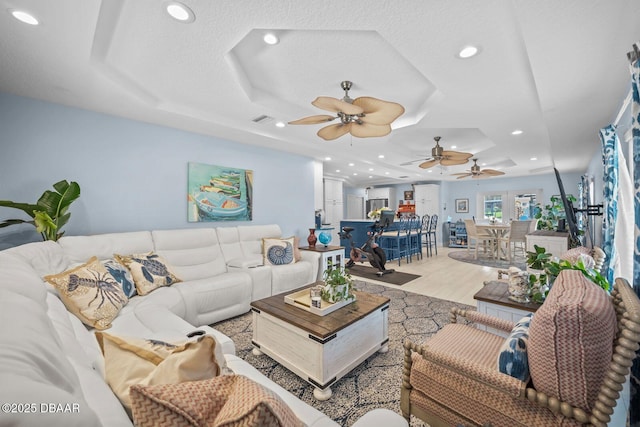 1942 N Daytona Ave, Flagler Beach, FL 32136 - living room featuring ceiling fan, a raised ceiling, recessed lighting, and light wood finished floors