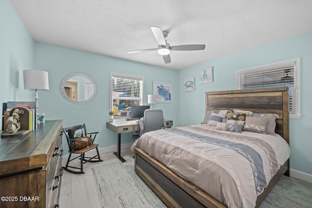1942 N Daytona Ave, Flagler Beach, FL 32136 - bedroom featuring a textured ceiling, a desk, baseboards, and a ceiling fan