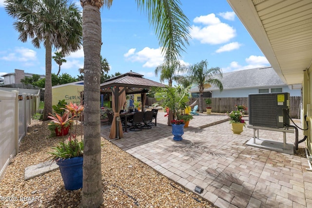 1942 N Daytona Ave, Flagler Beach, FL 32136 - fenced backyard featuring a gazebo, a patio, and central AC unit