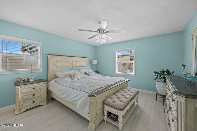1942 N Daytona Ave, Flagler Beach, FL 32136 - bedroom featuring baseboards, light wood-style floors, and a ceiling fan