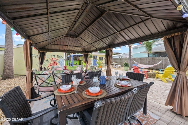 1942 N Daytona Ave, Flagler Beach, FL 32136 - fenced backyard featuring a patio, an outdoor fire pit, and outdoor dining area